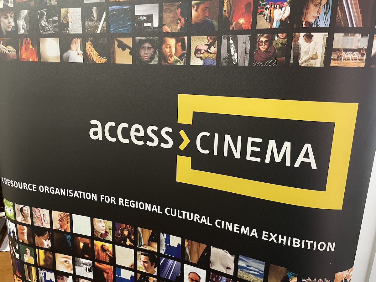 The access>CINEMA logo and film images on a pop-up poster.