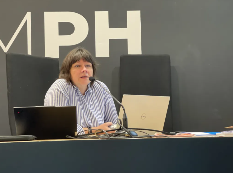 Erika Borsos of Schikaneder Kino & Top Kino, Austria sitting at a chair while speaking at a conference